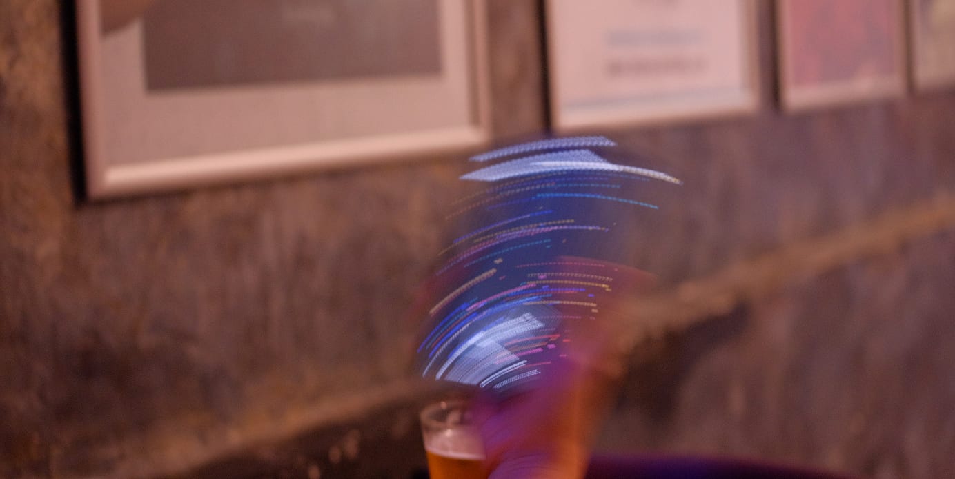 the shake as pure light: the phone gone, only the arc it drew